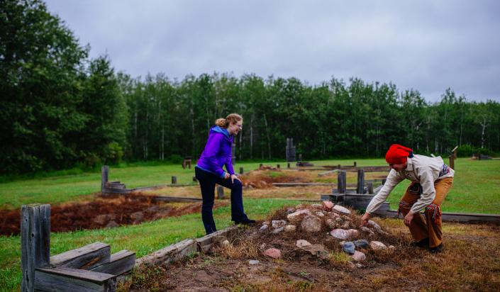 Staff and visitor at old fort site