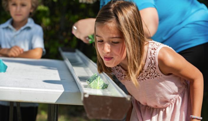 Middle elementary school student participating in a school program that involves paper boats